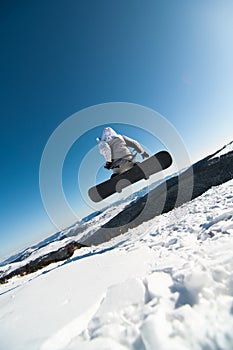 Snowboarder jumping in the snow