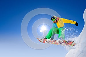 Snowboarder Jumping on Snowboard in the Mountains. Snowboarding and Winter Sports