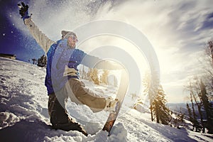 Snowboarder jumping from the springboard against the sky