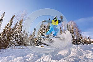 Snowboarder jumping from the springboard against the sky