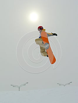 Snowboarder Jumping and sun