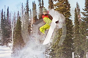 Snowboarder jumps at offpiste slope photo