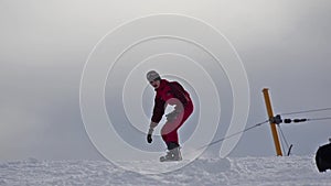 Snowboarder Jumps on skyslope