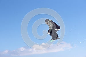 Snowboarder jumps in Snow Park