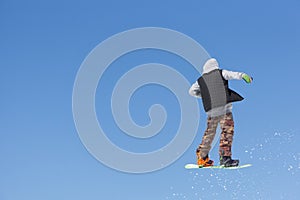 Snowboarder jumps in Snow Park