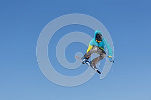 Snowboarder jumps in Snow Park