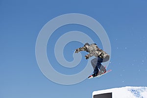 Snowboarder jumps in Snow Park