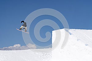 Snowboarder jumps in Snow Park