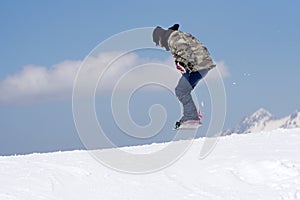 Snowboarder jumps in Snow Park