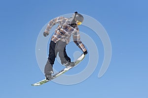 Snowboarder jumps in Snow Park