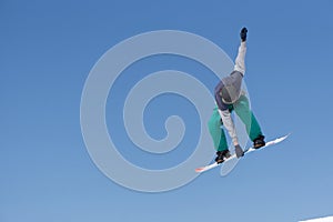 Snowboarder jumps in Snow Park