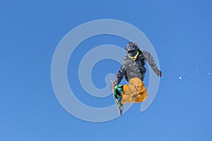 Snowboarder jumps in Snow Park