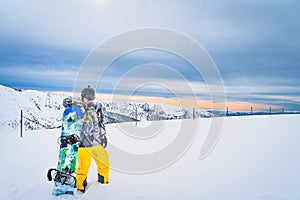 Snowboarder leaning on a snowboard on the top of the Pyrenees Mountains, Andorra