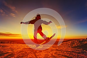 Snowboarder on the mountain with a sunset