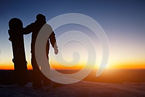 Snowboarder on the mountain during sunset photo