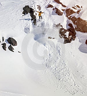 Snowboarder moving down in mountains