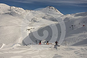 Snowboarder in the park on a box. Snow park box tricks. Winter jibbing in snwopark in France