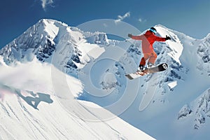 snowboarder performing jump against snowcapped peaks