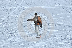 Snowboarder in powder snow with walkie-talkie