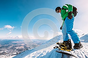 Snowboarder prepare to ski down from the top of snow hill