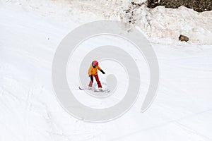 Snowboarder rides down a snow slope