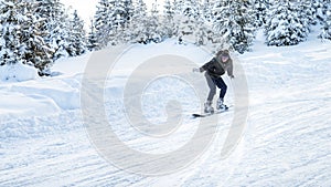 Snowboarder rides in motion on the ski slopes