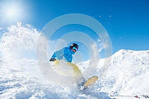 Snowboarder riding down the slope