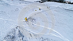 Snowboarder riding down the slope, aerial view