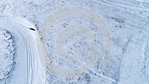Snowboarder riding down the slope, aerial view
