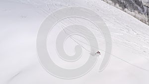 Snowboarder riding free rid on snowboard on powder fresh snowy slope on winter forest landscape. Aerial view snowboarder riding on