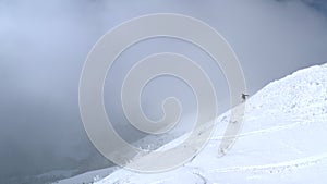 Snowboarder riding free rid on snowboard on powder snowy slope on winter forest landscape. Aerial view snowboarder riding on downh