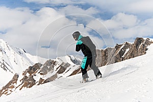 snowboarder riding freeride on powder snow down the slope