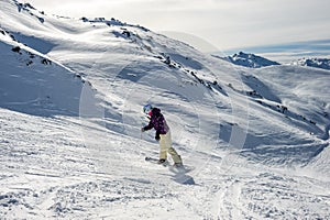 Snowboarder riding at French Alps mountain slopes