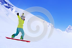 Snowboarder running down slope