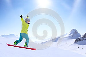 Snowboarder running down slope