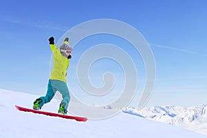 Snowboarder running down slope