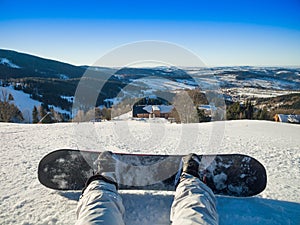 Snowboarder sitting on a snow