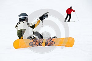 Snowboarder and skier