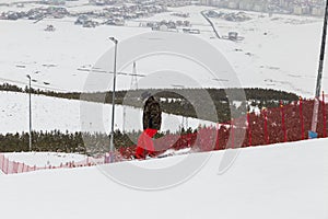 snowboarder, skier skiing from downhill