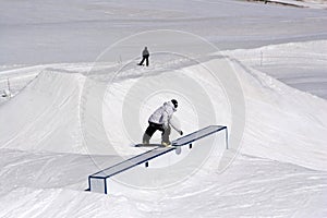 Snowboarder sliding on a box