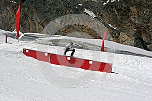 Snowboarder sliding on a box