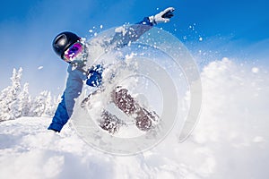 Snowboarder on snowboard rides through snow, explosion.