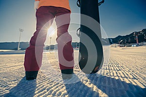 snowboarder with snowboard on ski piste