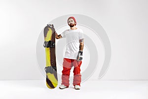 Snowboarder with snowboard in studio