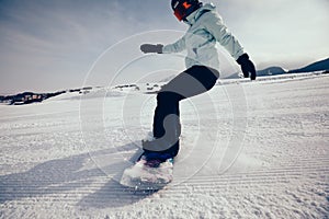 Snowboarder snowboarding in mountains