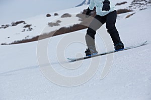 Snowboarder snowboarding in winter mountains