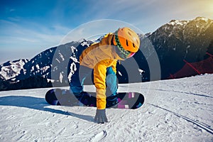 Snowboarder snowboarding in winter mountains