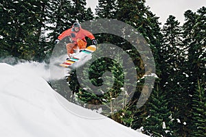 Snowboarder with special equipment is jumping hight and freeriding