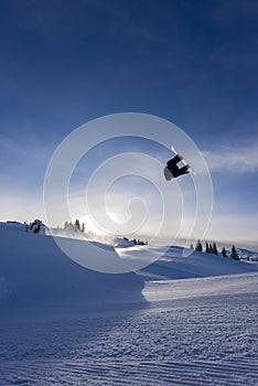 Snowboarder spinning doing a grab in the air