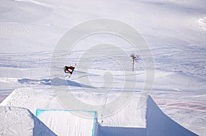 Snowboarder spinning doing a grab in the air